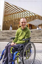 Vertical portrait of a happy caucasian adult man with disability in the university