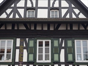 Traditional half-timbered house with green shutters and detailed wooden structure, kandel, germany