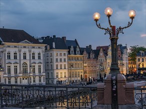A picturesque old town street at dusk with illuminated historic buildings and lanterns, historic