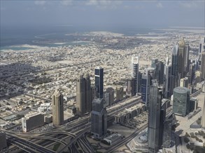 Panoramic view of a city with modern skyscrapers along the coast and the sea in the background, Abu