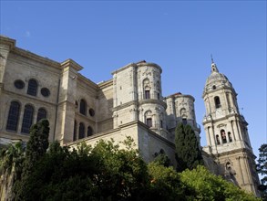 Large cathedral with impressive stone towers and detailed facades under a blue sky, The city of