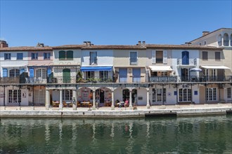 Townscape with restaurants and shops at the Pont principal du port grimaud, Port Grimaud, Var,