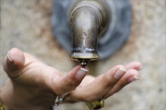 Close Up on a Woman's Hand Touching a Water Drop From a Water Well in Switzerland
