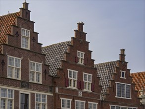 Historic gabled brick houses arranged in rows, with pointed roofs and windows in a traditional
