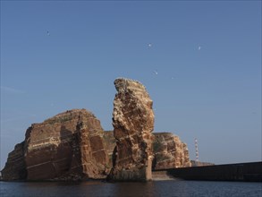 Dramatic cliff formations rise out of the sea into the sky, Heligoland, Germany, Europe