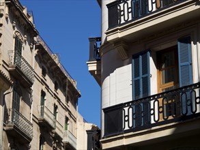 Urban architecture with multiple balconies and shutters, under a clear blue sky, palma de Majorca