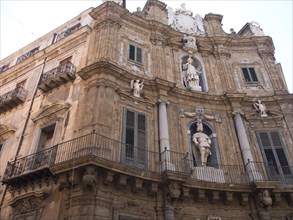 Baroque facade of a historic building with ornate sculptures and balconies, palermo in sicily with