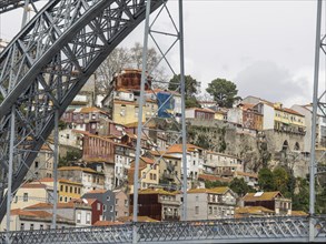 View of a hill town with colourful houses and a large bridge in the foreground, Colourful houses on