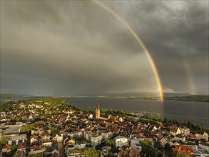 Aerial view of the town of Radolfzell on Lake Constance in front of sunset, with a double rainbow