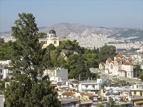 A church and a castle on a hill overlooking a cityscape, Ancient buildings with columns and trees