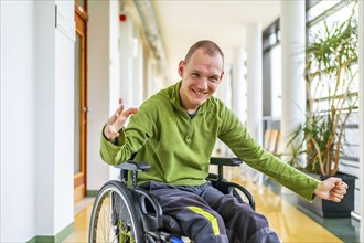 Happy caucasian adult man with disability happy in the corridor of the university