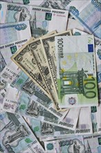 Background of paper bills dollars, euros and rubles. Currency exchange rate