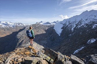 Hiker looking at mountain panorama and glacier, view of Gurgler Ferner with summit Hochwilde and