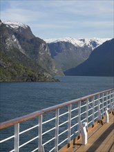 View from the deck of a ship on the water and snow-capped mountains in the background, cruise