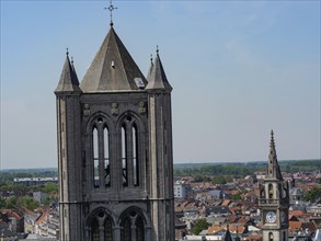 Close-up of an impressive church tower and a smaller tower in the background, overlooked by a clear