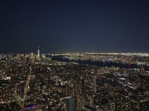 Night skyline of New York with illuminated skyscrapers and dark sky, new york from above with
