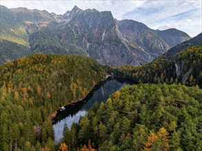 Aerial view, mountain peaks of the Oetztal Alps reflected in Lake Piburger See, in autumn, near