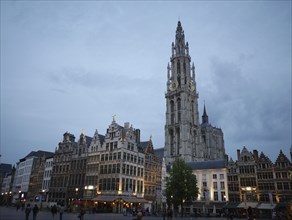 City view with church and historic buildings at dusk, the historic market square of Antwerp at
