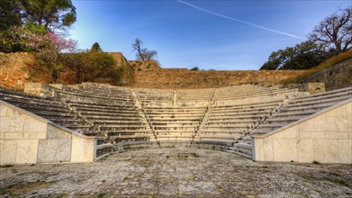Ancient amphitheatre with stone seating steps, illuminated by soft morning sunlight, Archaeological