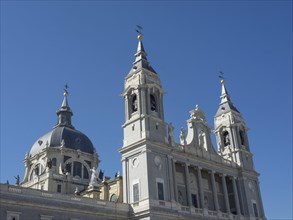 A historic church building with domes and towers under a clear blue sky, Madrid, Spain, Europe