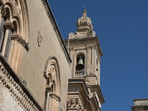 Baroque elements of a historic church tower with bell and decorated facade, Historic buildings with