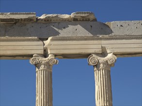 Close-up of ancient doric columns under a clear blue sky, ancient columns in front of a blue sky,