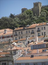 Panorama of houses with a hill and a castle in the background, Lisbon, Portugal, Europe