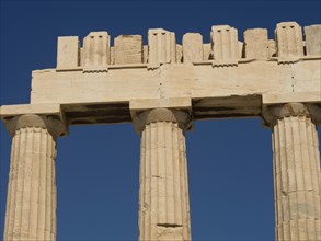 Detailed view of ancient columns of a temple under a clear blue sky, Ancient buildings with columns