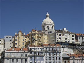 A group of houses in the historic centre with a dominant dome on one house, Lisbon, Portugal,