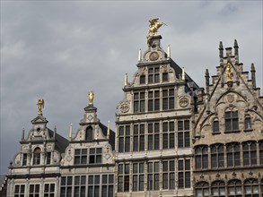 Historic buildings with magnificent facades and statues under a cloudy sky, Historic buildings on