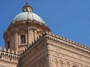 Large dome of the gothic cathedral under a clear blue sky, historic cathedral with towers in front