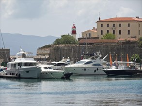 Harbour with several luxury yachts, a building and a lighthouse, Corsica, ajaccio, France, Europe