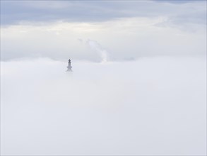 Church tower rises out of the morning mist, Frauenberg pilgrimage church, near Leibnitz, Styria,