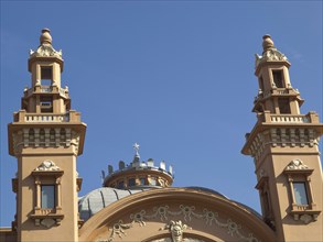 Ornate towers of a historic building against a clear blue sky, The city of Bari on the