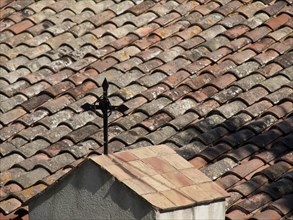 Close-up of a rustic tiled roof with simple vane and patterned tiles, la seyne sur mer, france