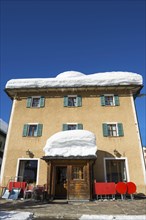 A House with Lot of Snow in a Sunny Winter Day in San Bernardino, Grisons, Switzerland, Europe