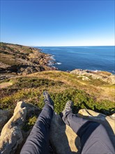 Sitting on a rock looking at the sea on Mount Jaizkibel next to San Sebastian, Gipuzkoa, Basque