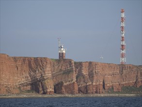 Red rock islands with antenna, calm sea, clear sky, Heligoland, germany
