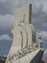 Monument with impressive sculptures under a clear sky, Lisbon, Portugal, Europe