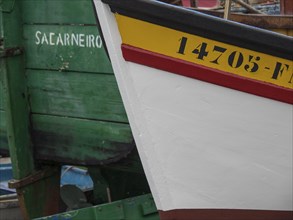 Close-up of painted boats in the harbour, mainly in green, yellow and white, the island of Madeira