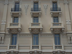 View of a decorative building facade with several balconies and windows in a historical style,