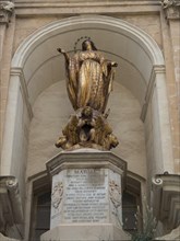 Golden statue of St Mary above an inscription in an arched frame, Valetta, Malta, Europe