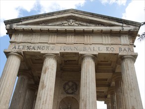 Ancient temple with columns and inscription under a blue sky, Valetta, Malta, Europe