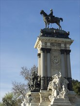 Tall statue of a rider on a horse, part of a large monument in the park, Madrid, Spain, Europe
