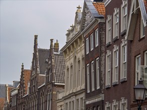 Historic buildings in an old town with ornate facades and tiled roofs, historic houses in Hoorn and