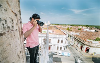 Tourist photographing the streets of Granada from the La Merced viewpoint. Tourist man taking
