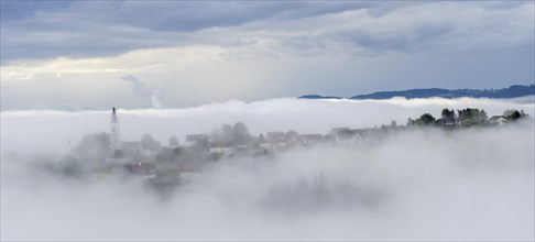 Fog clears over the village of Frauenberg, view from the Silberberg, near Leibnitz, Styria,