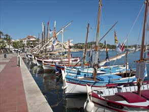 Several colourful sailing boats at the harbour in front of a blue sky, la seyne sur mer at the