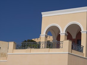 House with elegant arches and balcony in Mediterranean style under a blue sky, The volcanic island