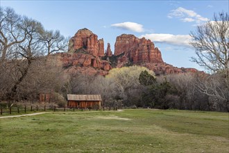Cathedral Rock sandstone formations tower over a rustic barn at the Crescent Moon Picnic Site in